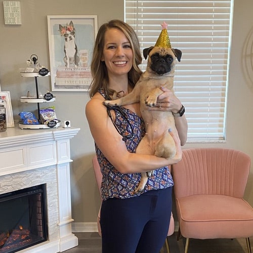 lady holding-her-pet lady holding her pet dog with a birthday hat